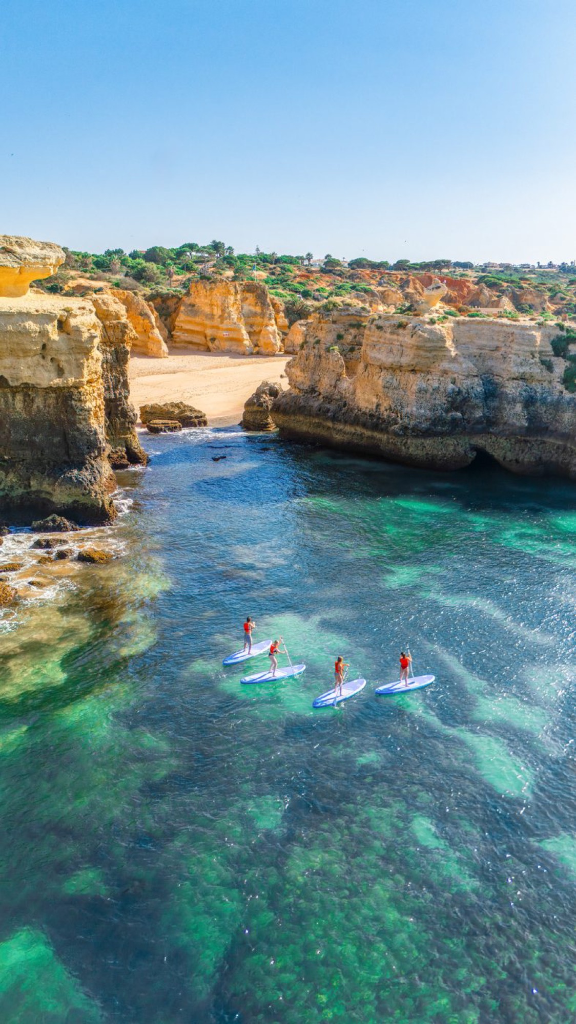 Paddler waving inside Algarve sea cave