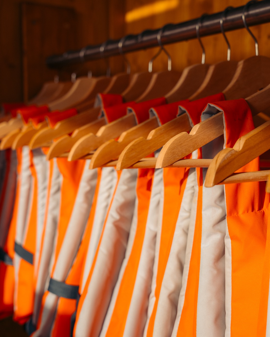 Row of orange life vests hanging ready for a tour