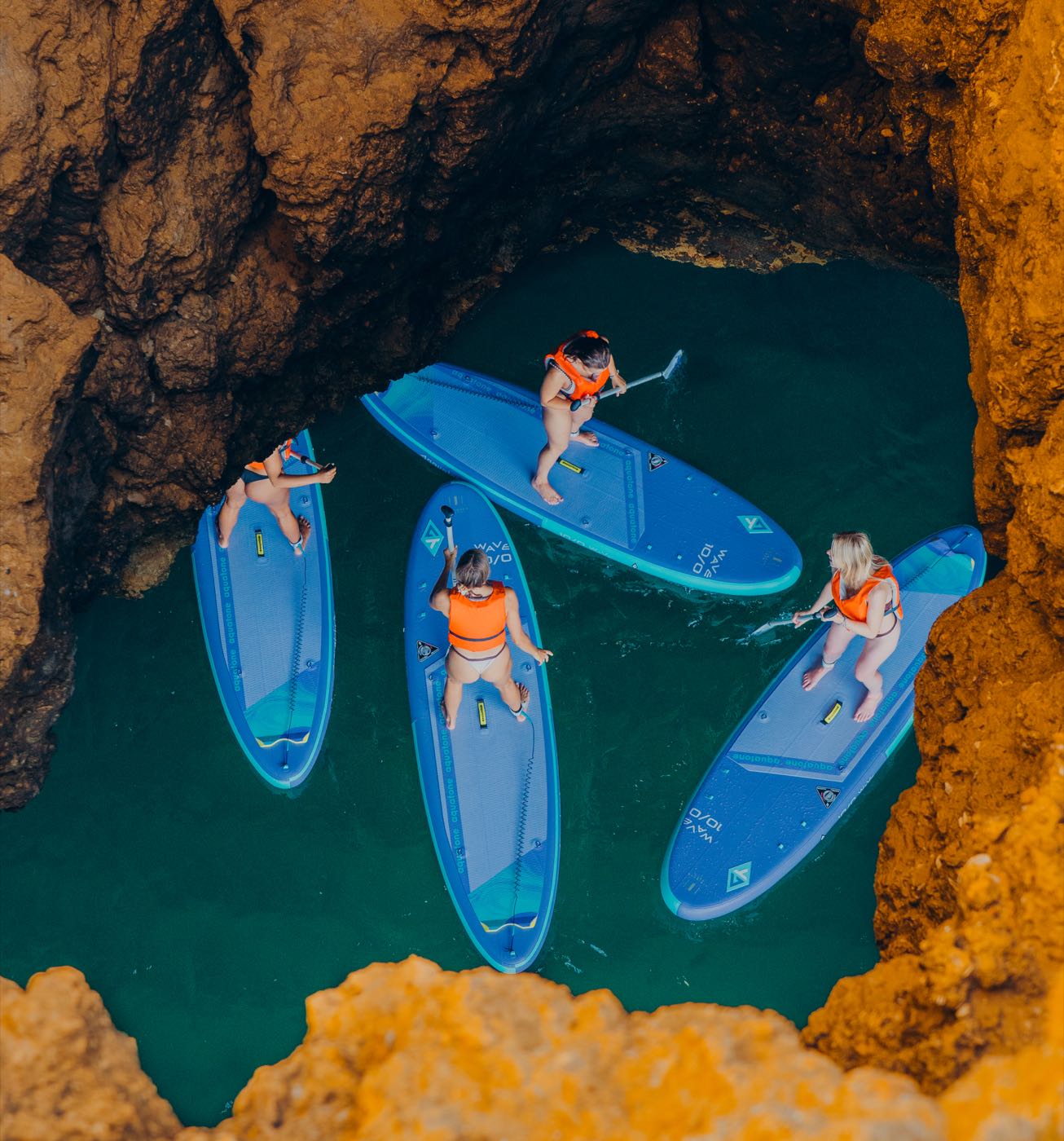 Aerial view of four paddlers inside an Algarve sea cave